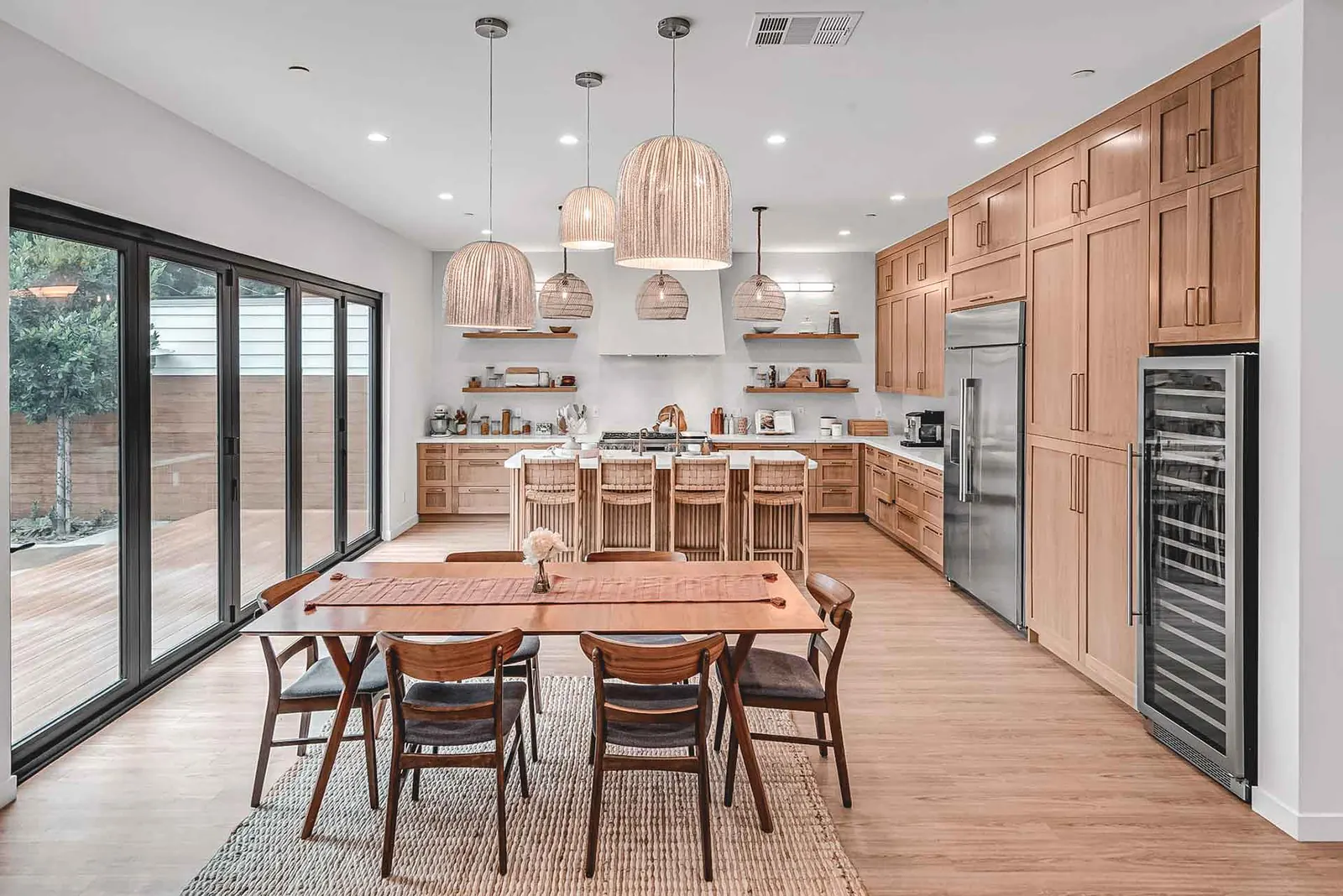 Contemporary open kitchen and dining room designed by Satin & Slate