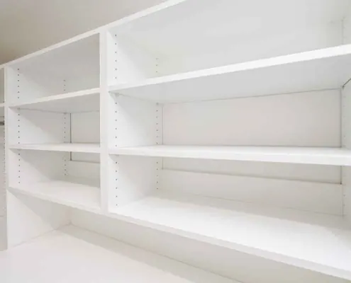 Adjustable shelves spaced closer together for shoes and further apart for folded clothes and handbags